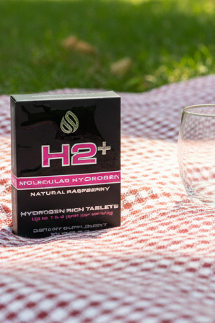 Packaging of H2 Molecular Hydrogen tablets on a gray background